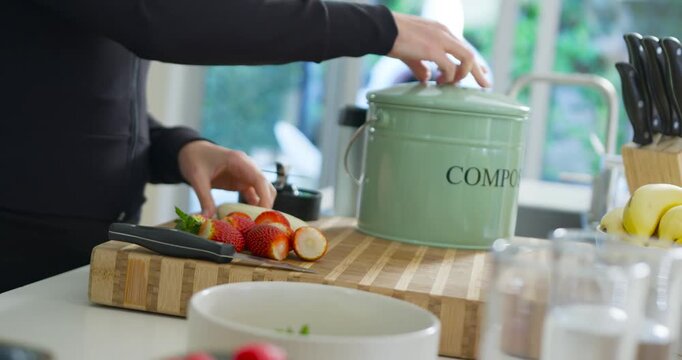 African American woman in black zip reaching COMPO lid slicing strawberries with knife, copy space