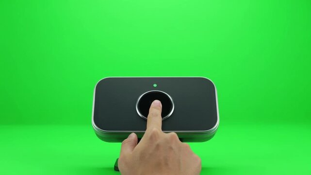 Hand scans fingerprint pressing button showing human trust and digital access with glowing confirmation light symbolizing security and activation on green screen background