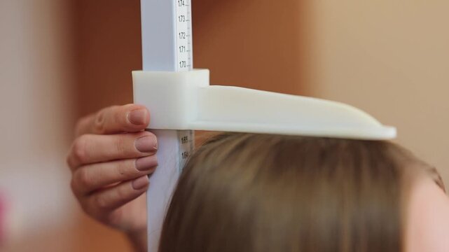 Measuring height with a ruler in a classroom setting during a learning activity