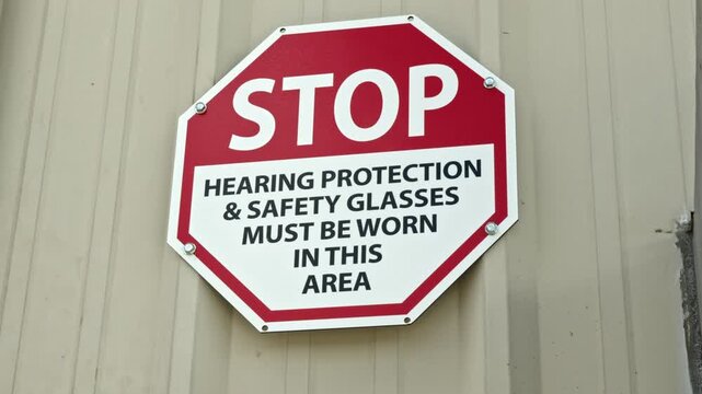 Industrial Stop Sign Requiring Hearing Protection and Safety Glasses PPE in a Manufacturing Facility