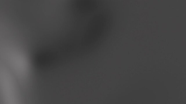 Abstract dark grey gradient background with soft wavy fluid motion