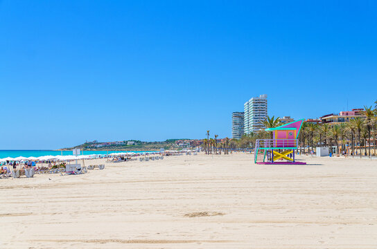 Playa de San Juan beach in Alicante city, colorful Lifeguard Hut Lifeguard Tower on sandy beach of Mediterranean Sea coast Costa Blanca coastline in sunny summer day, Valencian Community, Spain