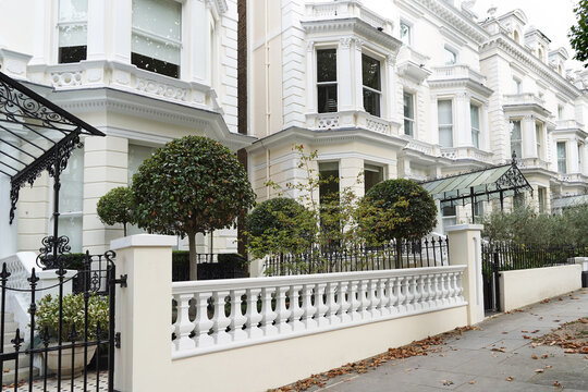 Long row of white stucco townhouses in Holland Park area of London