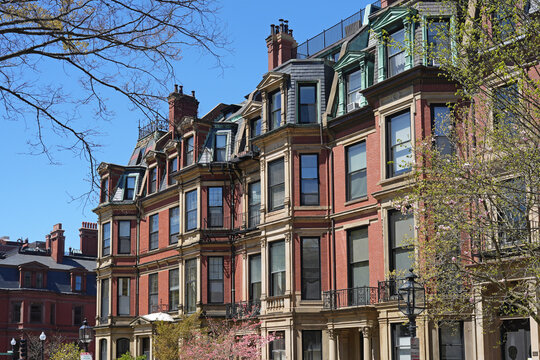 Long row of elegant old townhouses with bay windows