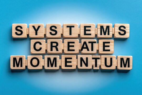 Systems create momentum phrase written with wooden tiles on blue background