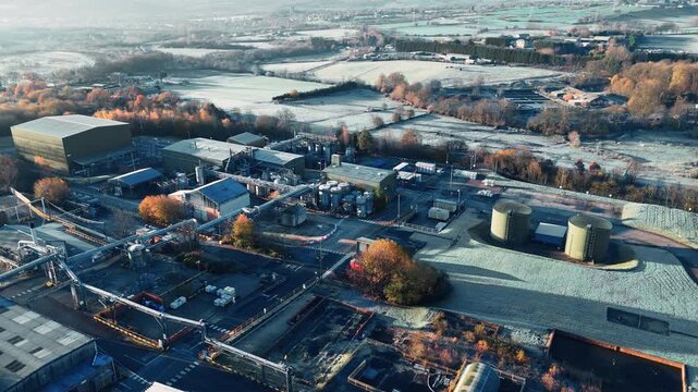 Cold morning fog wraps around industrial complex. Industrial chemical plant