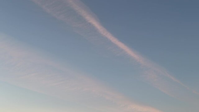 Pre sunset sky time lapse with soft airplane contrail and evening cloud
