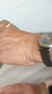 Vertical video: Using chopsticks by green bowl, right hand picking at table sharing meal