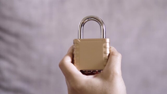 Hands setting a combination padlock for security