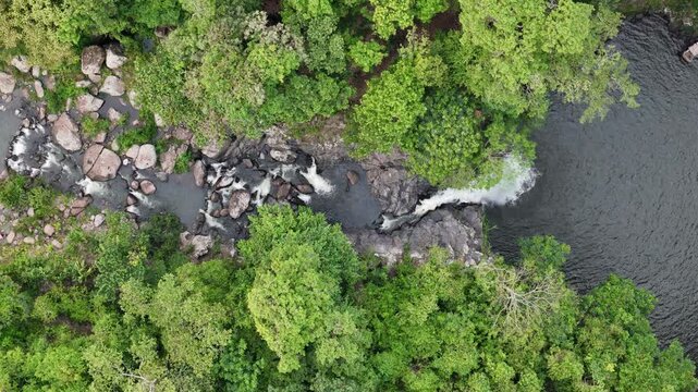 River flow in rock stone shore with waterfall aerial above top view