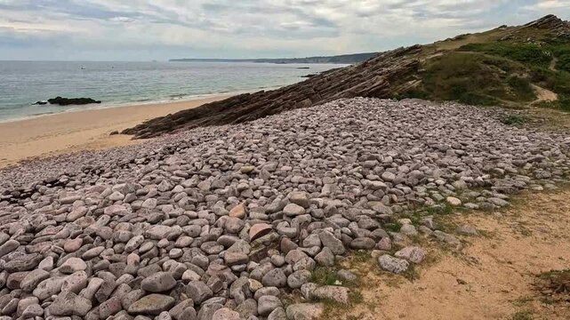 Man-Made Stone Barrier and Natural Coastal Rocks Protecting the Shoreline from Erosion.
Engineered stone barriers and natural coastal rock formations work together to protect the shoreline from erosio