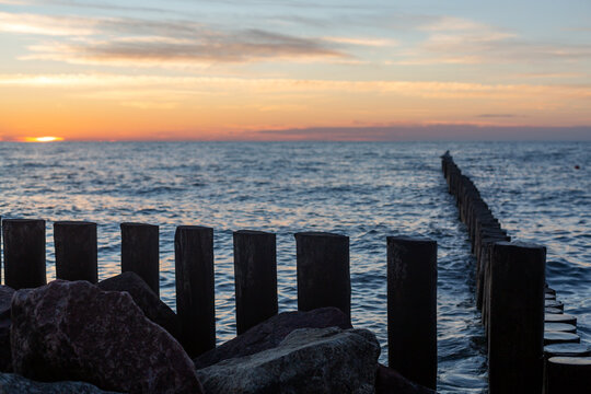 Wooden posts extending into the Baltic Sea at sunset in Svetlogorsk