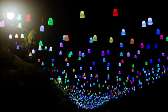 Colorful hanging lights illuminate a night scene in Svetlogorsk, Baltic region