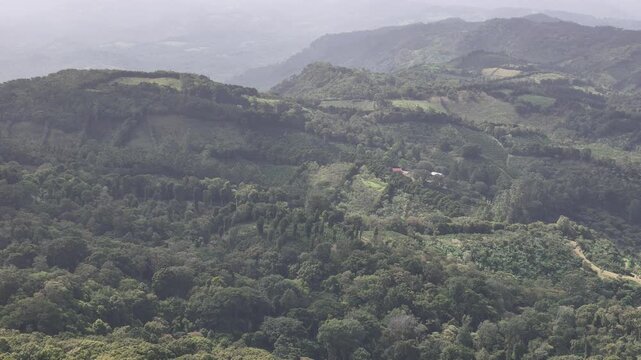 Farm place on green mountain hill aerial drone view