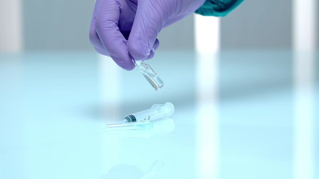 hand holding a syringe