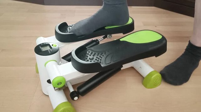 Close up detail of mini stepper hydraulic mechanism showing pistons and resistance system, technical product view for fitness enthusiasts.