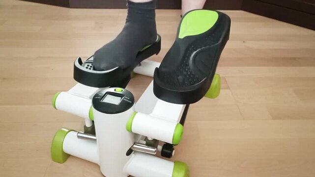 Dual foot position on mini stepper showing balanced stance, fitness equipment usage demonstration for leg strengthening exercises.