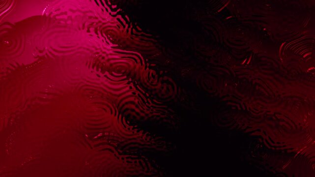 Red liquid creates captivating patterns with shadows and reflections. Ideal for backgrounds, packaging design, abstract concepts, and textures.