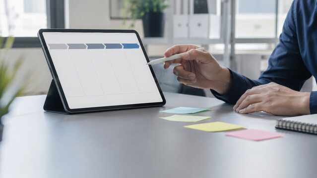 Custom software development planning on digital tablet with stylus in modern office environment, creative and focused atmosphere