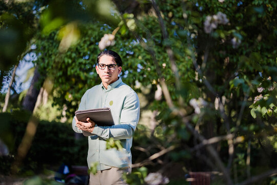 Latino biologist with tablet studying climate change