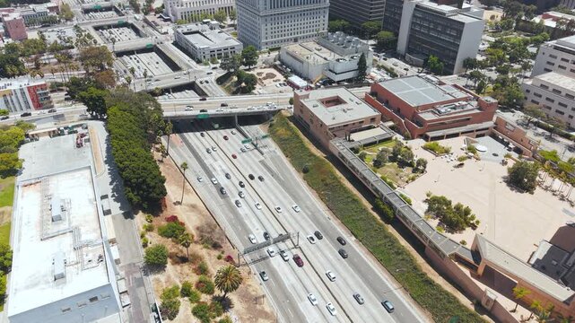 Drone Shot of US 101 Highway Traffic by Downtown Los Angeles on Hot Sunny Day, California USA