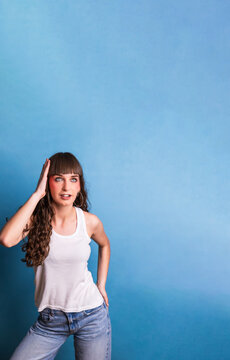 Dancer performing expressive movements on blue background