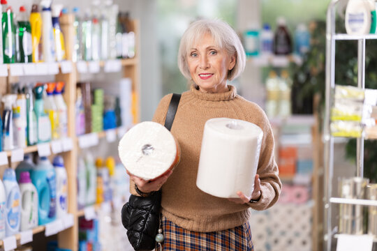 Mature woman choosing paper towels in store