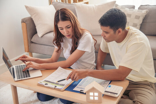 Couple lover make home financial plan. Young asian lover planning retire plan at home bedroom look at investment graph chart. Family finance investment happy together.
