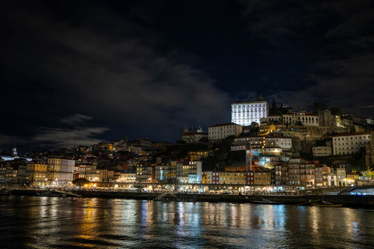 Historic Buildings in Downtown Porto on the Douro River at Night Illuminated