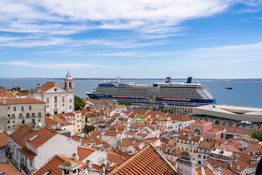 Lisbon Portugal - September 24 2024: A Large Cruise Ship Docked Near the Historic City Center in Lisbon Portugal With Many Building Rooftops