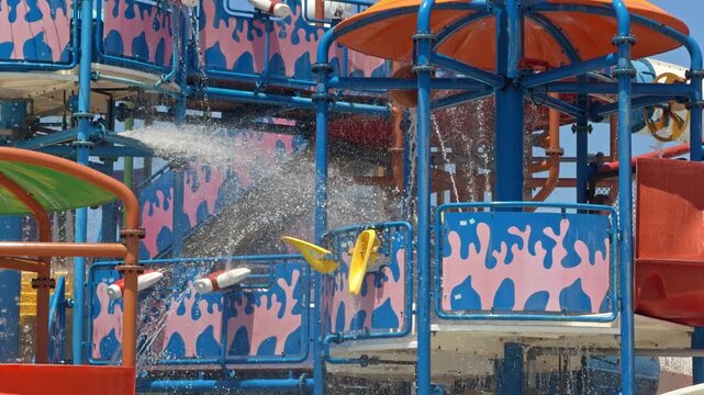 A water jet sprays from a colorful play structure panel at an aqua park in Cesme Turkey
