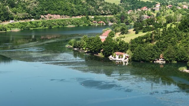 Drone Shot of Lake in Ovcar Kablar Gorge, Lakefront Homes and Road Traffic on Sunny Day, Serbia