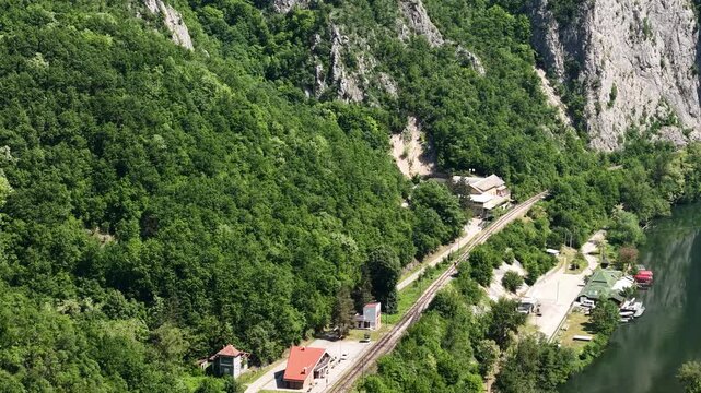 Drone Shot of Ovcar Banja Station, Railway and Mountaineer Home Above Zapadna Morava River, Serbia
