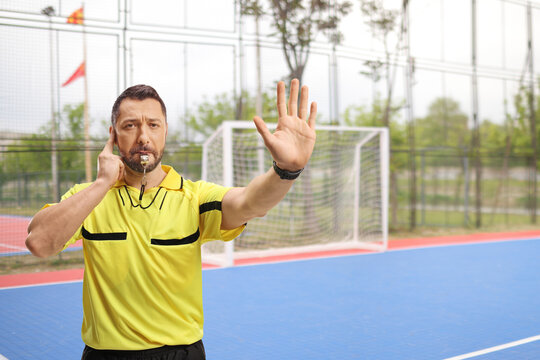 Football referee blowing a whistle