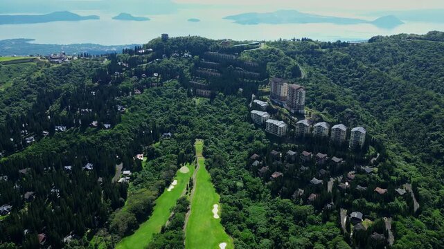 Professional panoramic aerial footage of Woodridge Place in Tagaytay City Cavite Philippines showcasing luxury hospitality, scenic mountain roads, lush greenery, Taal Volcano as backdrop.