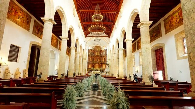 Interior of Santa Catalina Cathedral in Cartagena with ornate altar and arches, medium symmetrical tilt down