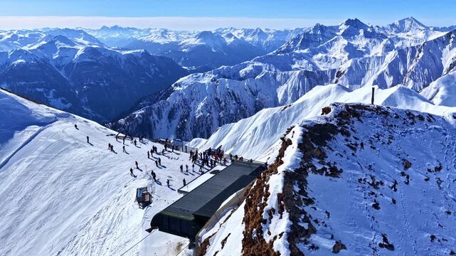 Snow-covered mountain ridge with building, Serfaus-Fiss-Ladis, Austrian Alps, winter travel destination.