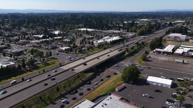 Aerial of I5 highway interchange and commercial area in Clark County Washington with multiple lanes of traffic in summer