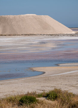 Pink salt pans, natural evaporation ponds, reflecting the late afternoon sun at salt works in Giraud, Camargue, Rhone delta, Provence, south of France.