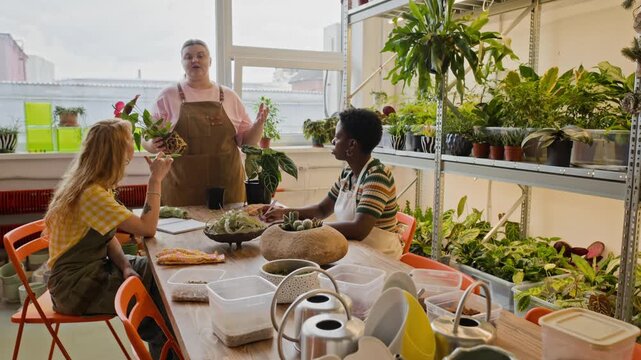 Plus-size Caucasian young adult woman teaching plant care to Caucasian and African American young adult women. Footage is ideal for promoting local community classes or eco-friendly brands