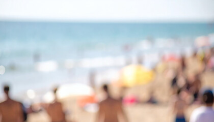 Obraz premium Blurred beach background featuring unrecognizable people relaxing on sandy shore during a sunny summer day with soft natural lighting