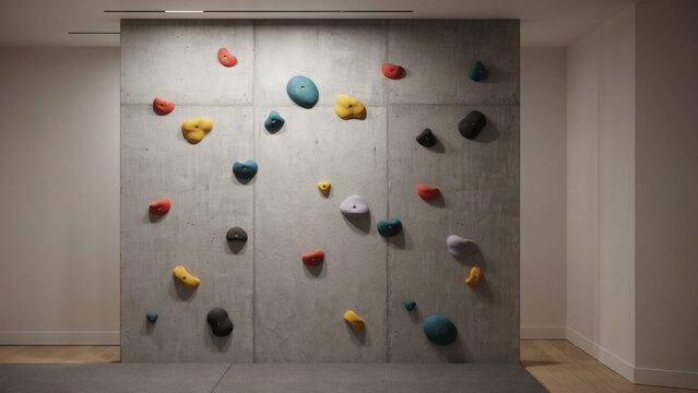 Indoor rock climbing wall with colorful holds in a gym or recreation center setting