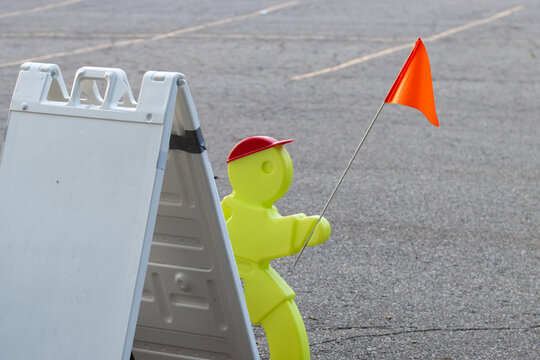 Yellow child safety warning sign with orange flag