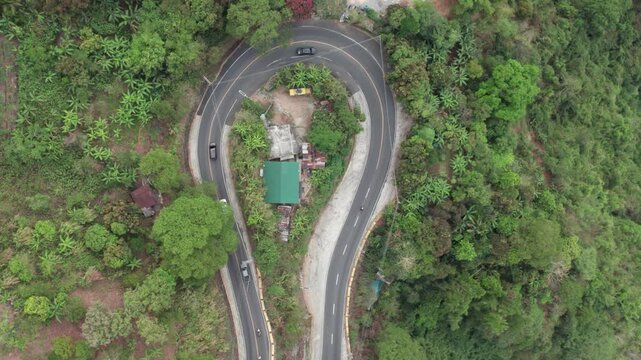 Aerial Top-Down View of Vehicles Navigating a Winding Hairpin Curve on Kennon Road, Philippines