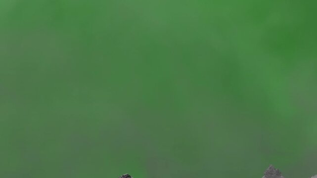 Crack in a cement wall. Intro with destruction. Broken wall. Concrete wall destruction. Animation of a concrete wall destruction with dust against a green screen background. Concrete explosion.