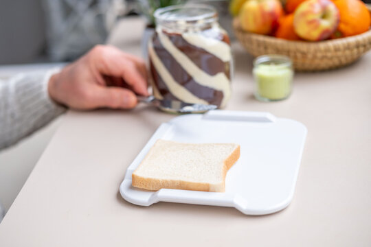 Elderly one-handed man using adaptive non-slip cutting board, independent meal disabled, stroke survivors, arthritis patients in home care, occupational therapy, senior living, food preparation tools