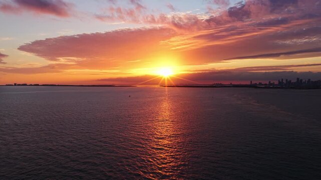 Sunset cloudy sky. Seascape at summer vacation. Skyscape with sea horizon. Horizon sunrise sea with ship. Sunrise seascape. Romantic summer vacation Florida seascape. Sea sunset horizon