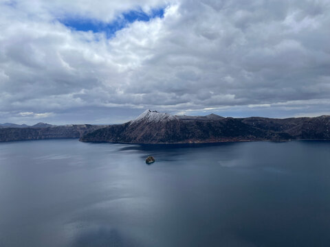 Lake Mashu and Kamuishu Island Under Dramatic Clouds in Hokkaido Japan