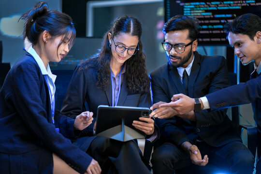 A diverse team of AI developers presents a project update during a video conference. A female lead points at the screen, explaining the architecture of a new generative AI model.
