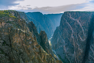 Deep dark gorge of Black Canyon plunges to the Gunnison River far below between sheer schist walls, Black Canyon of the Gunnison NP, Colorado. © ZL Visuals